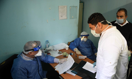 Egyptian doctors receive patients at the infectious diseases unit of the Imbaba hospital in the capi