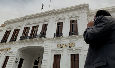 A man uses a mobile phone in front of the Egyptian Ministry of Health following an outbreak of the c