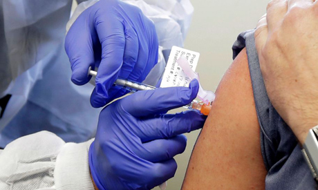 File photo: A patient receives a shot in the first-stage safety study clinical trial of a potential 