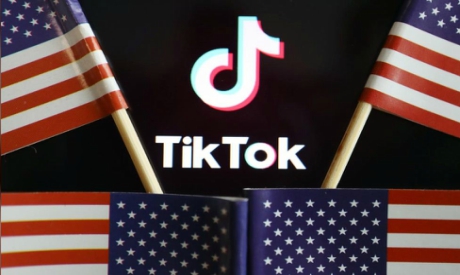 US flags are seen near a TikTok logo