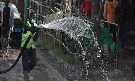 Ethiopian health worker sprays disinfectant in Addis Ababa