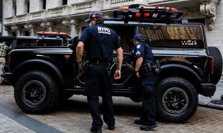 New York City Police (NYPD) officers look at a Ford Motor Co. REUTERS