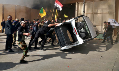 File photo, pro-Iranian militiamen and their supporters damage property inside the U.S. embassy comp