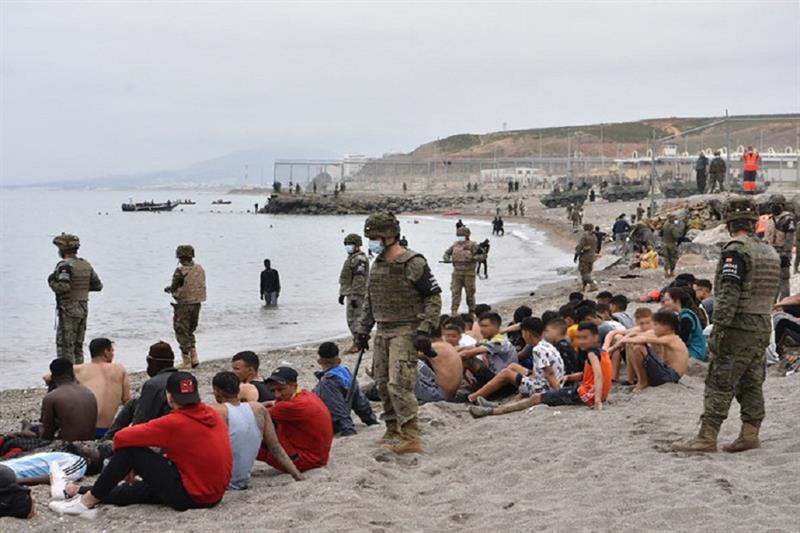 Migrants, including minors, who arrived swimming at the Spanish enclave of Ceuta