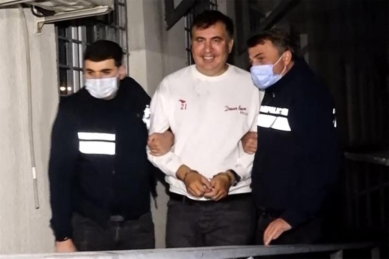 Former Georgia s President Mikheil Saakashvili escorted by police officer