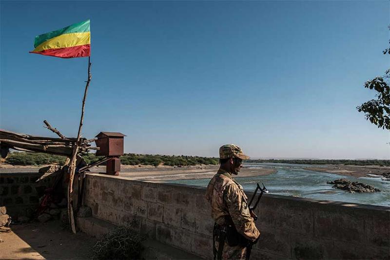A member of the Amhara Special Forces watches on at the border crossing with Eritrea where an outdat
