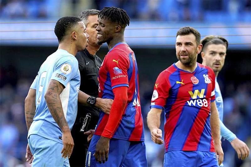 Manchester City s Gabriel Jesus, left, and Crystal Palace s Wilfried Zaha in discussion during the E