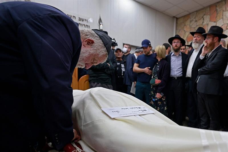 Mourners gather by the body of 25-year-old Eliyahu Kay during his funeral in Jerusalem