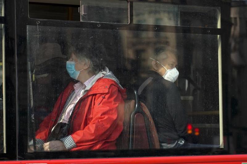  People wear face masks in London