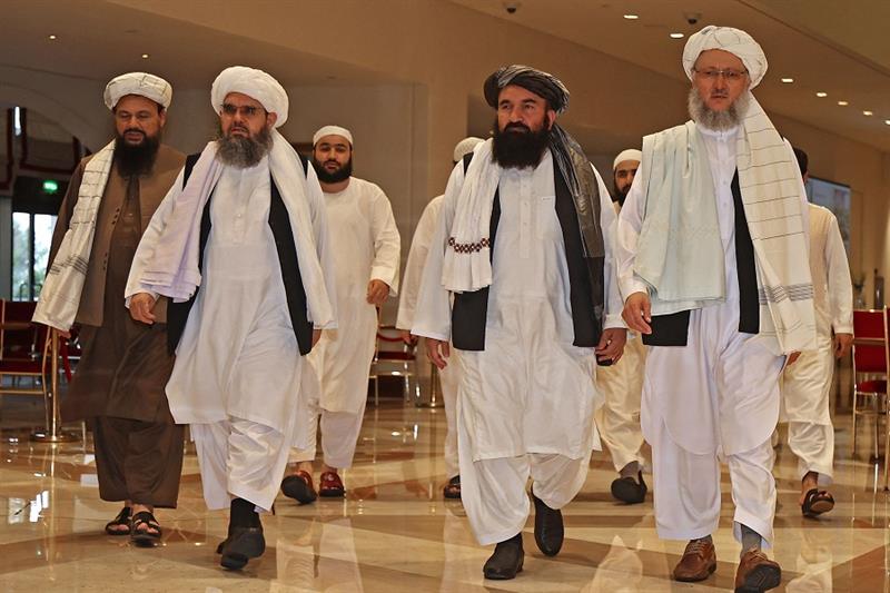 Head of the Taliban delegation Abdul Salam Hanafi (R), accompanied by Taliban officials (2R to L) Mu