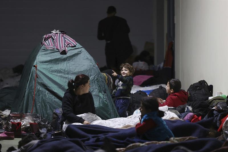 Migrants rest inside a logistics center at the checkpoint  Kuznitsa  