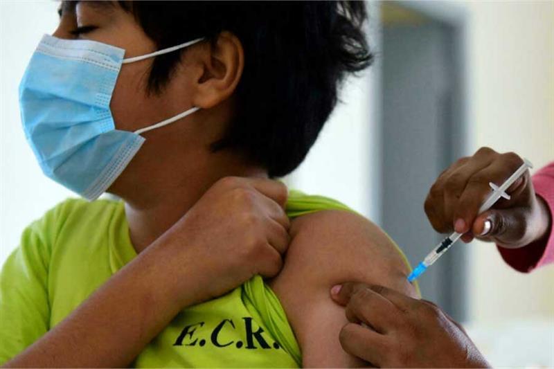 A child receives a dose of the Pfizer-BioNTech vaccine against Covid-19 at a vaccination center in A