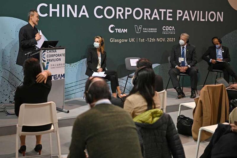 Former US Vice President Al Gore (2R) attends a panel discussion at the China Corporate Pavilion dur
