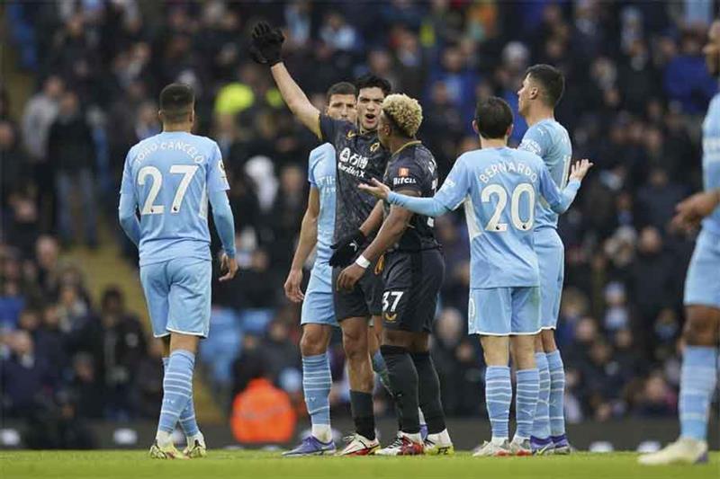 Manchester City s Raheem Sterling, right, scores his side s first goal on a penalty kick during the 