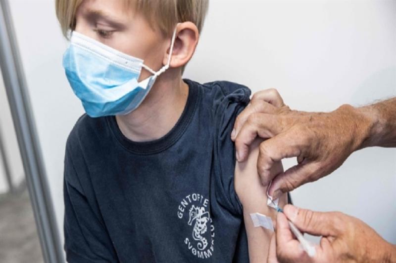 10 years old, boy eceives a vaccination against Covid-19