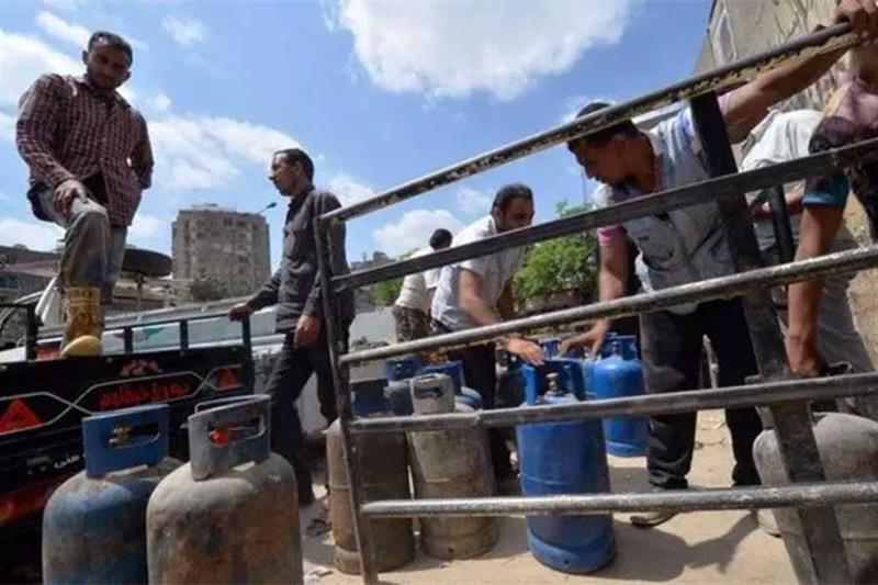 File photo: An Egyptian man loads gas cylinders onto a truck to be refilled at a warehouse in Cairo,