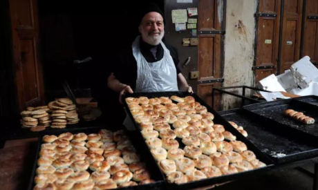 A baker displays fresh bread in Lebanon