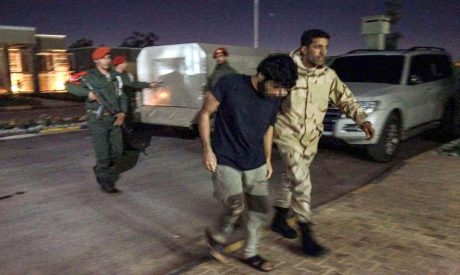 Soldiers escort a detained Turkish mercenary captured in Benghazi