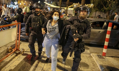 Israeli policemen arrest a Palestinian protester near the Damascus Gate in Jerusalem