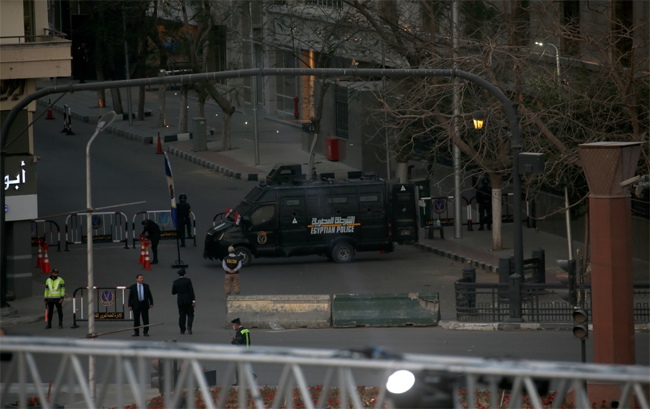 A police vehicle secures the entrance to Tahir Square as royal mummies are transported in a convoy f