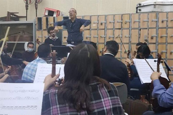 Ahmed El Mougy with maestro Nade Rabbassi and the orchestra during the Golden Parade rehearsals