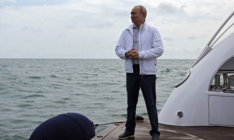 Russian President Vladimir Putin stands on a boat during trip on the Black Sea with his Belarusian c