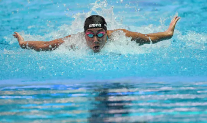 Egypt s Farida Osman competes in a heat for the women s 50m butterfly event during the swimming cp