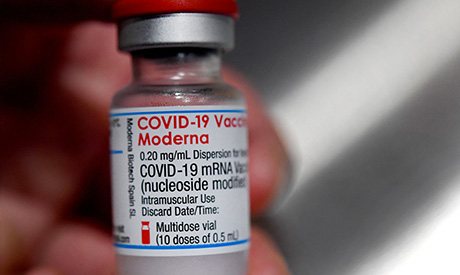 File photograph taken on June 29, 2021, a medical official holds a vial of the Moderna Covid-19 vacc