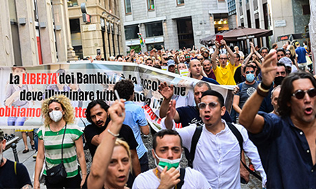 Protesters take part in a demonstration in Milan on July 24, 2021, against the introduction of a man
