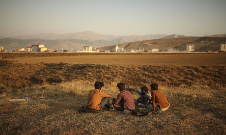 Afghan migrants sitting 