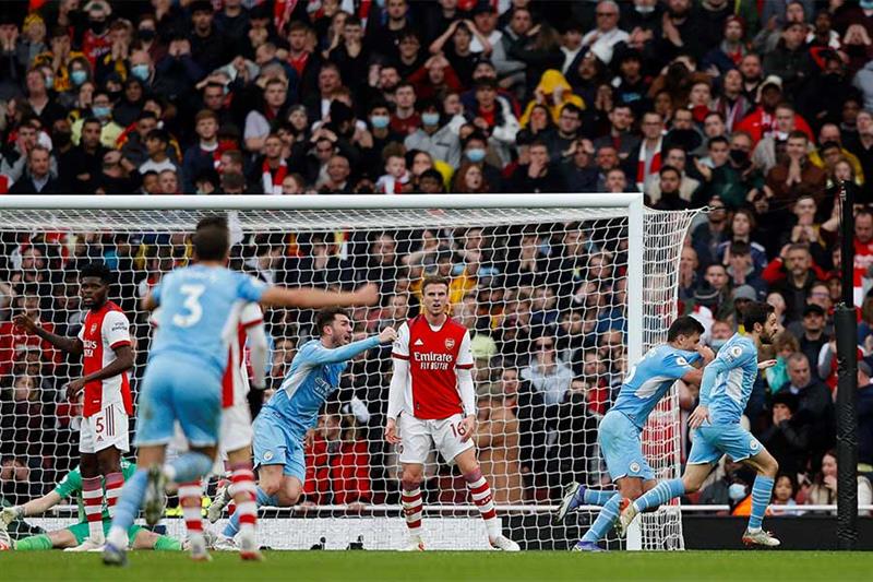Manchester City s Spanish midfielder Rodri (2R) celebrates scoring his team s second goal during the