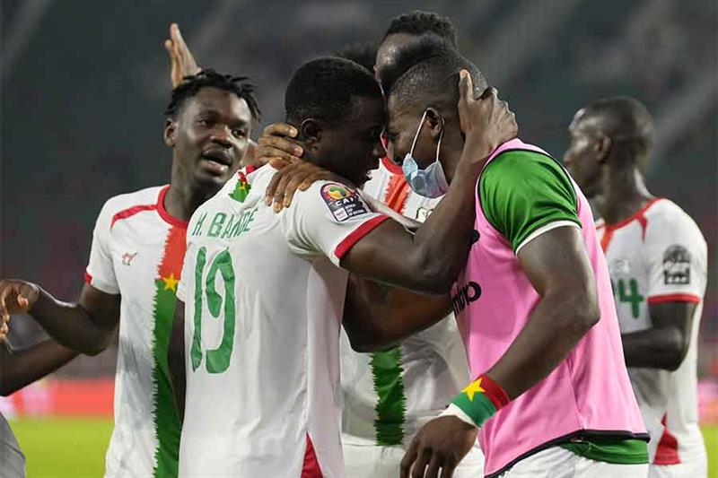 Burkina Faso s Hassane Bande, left, celebrates teammates after scoring a goal during the African Cup