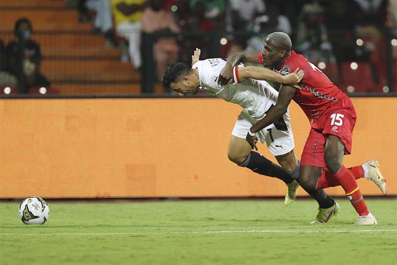 Egypt s Trezeguet, left, and Jefferson Encada of Guinea-Bissau fight for the ball during the African