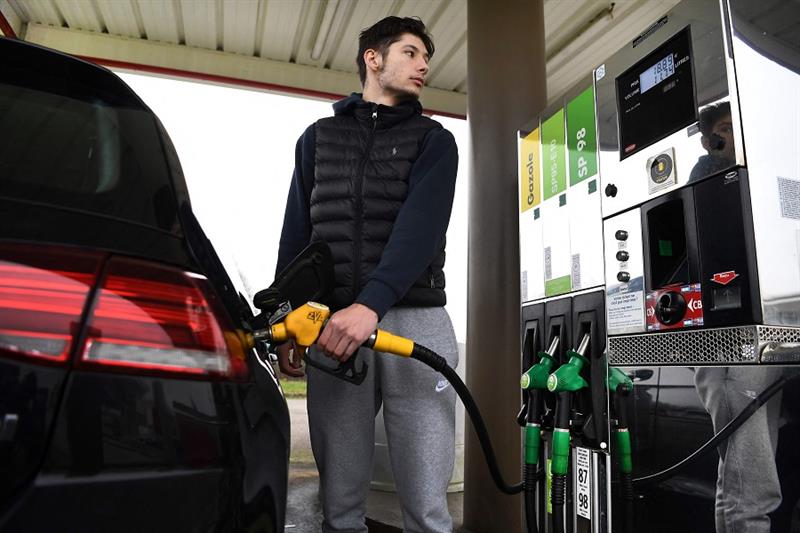 A driver fills his car tank at a petrol station in Ploneis, western France