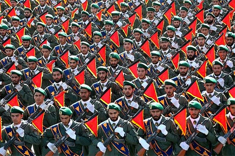Iran s Revolutionary Guard troops march in a military