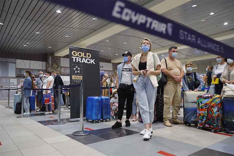 Russian tourists gather at the Egyptair check-in desk at the Domodedovo International Airport outsid