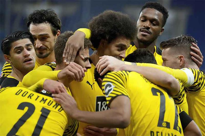 Dortmund players celebrate after scoring their side s third goal during a German Bundesliga soccer m