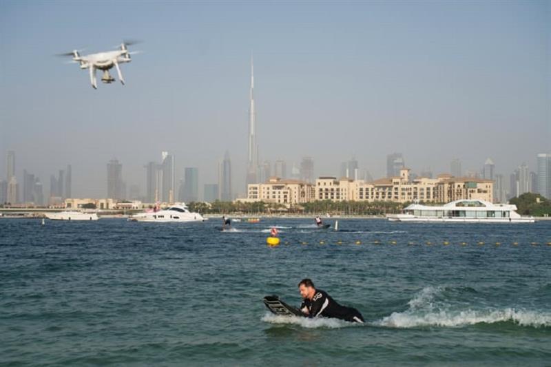 A drone follows a man riding a motorized surfboard in Dubai