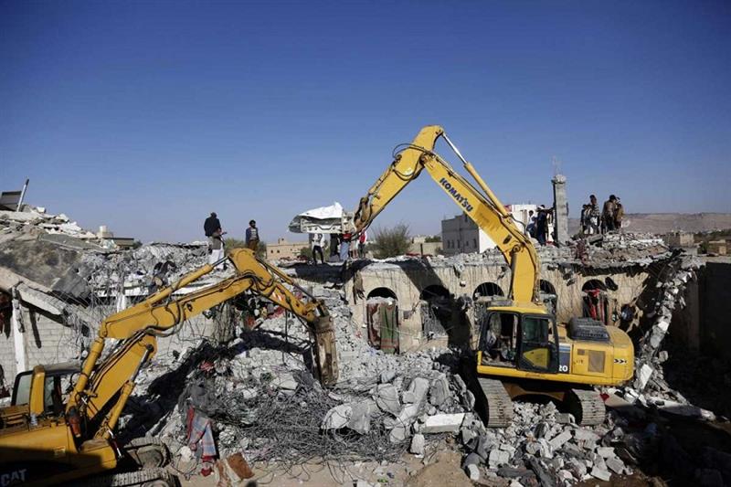 People search the rubble of a prison facility hit by a Saudi-led coalition airstrike in Yemen