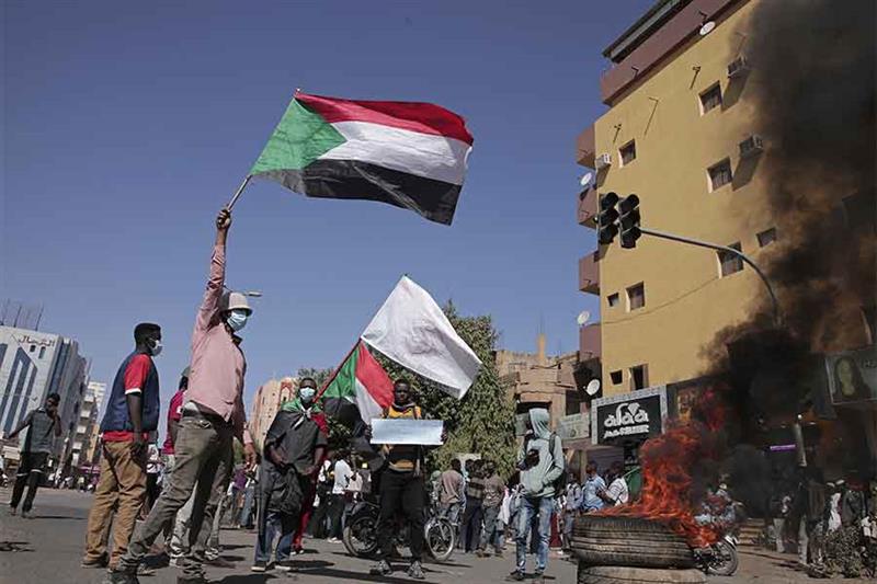 People chant slogans during a protest to denounce the October 2021 military coup, in Khartoum, Sudan