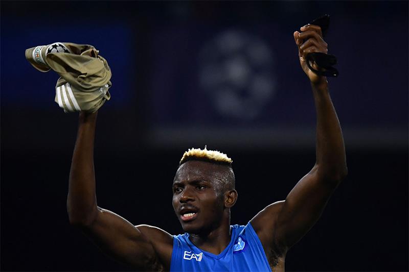 Napoli s Nigeria s forward Victor Osimhen celebrates after winning the UEFA Champions League Group A