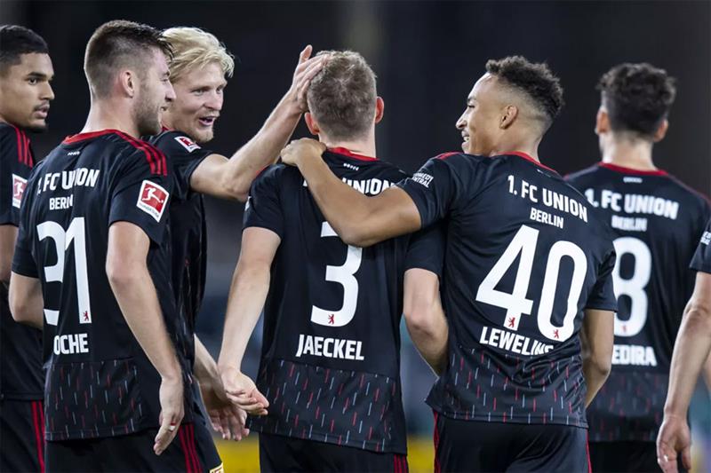 Union Berlin s Paul Jaeckel, center, celebrates scoring with teammates during the Bundesliga soccer 