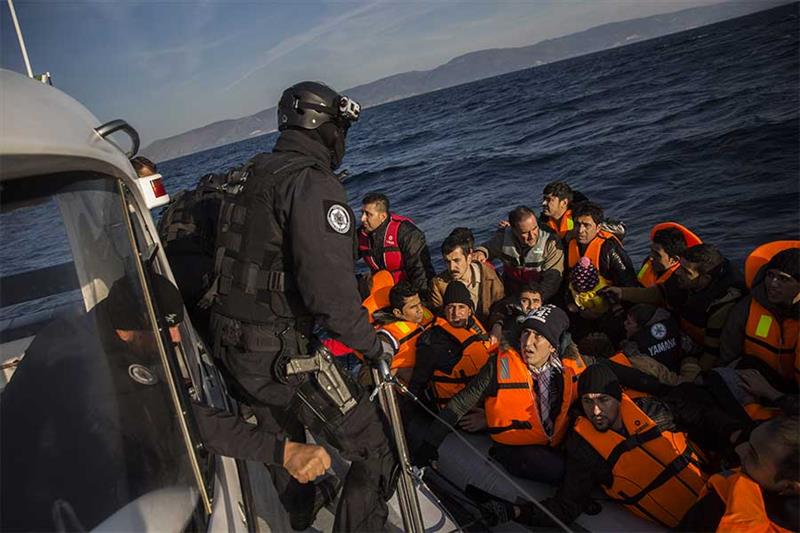 FILE - Members of the Frontex, European Border Protection Agency, from Portugal rescue 56 people, wh