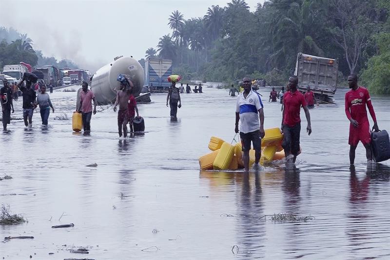People wade through flooded roads In Bayelsa, Nigeria