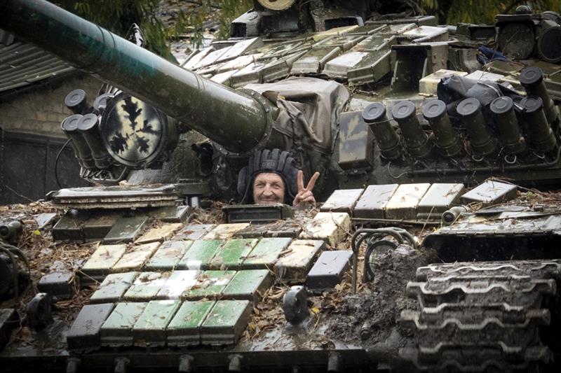 Ukrainian soldier flashes a victory sign in Bakhmut, the site of the heaviest battle against the Rus