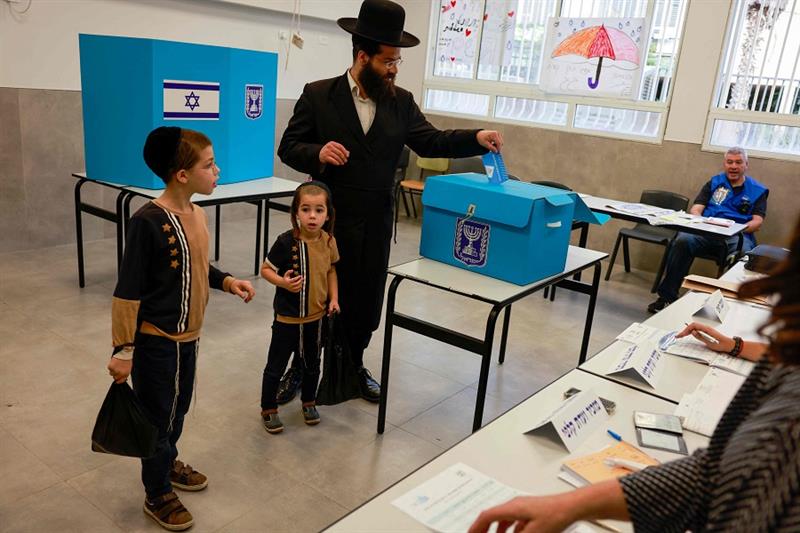 An ultra-Orthodox Jewish voter casts their ballot at a polling station in Bnei Brak, an Orthodox Jew