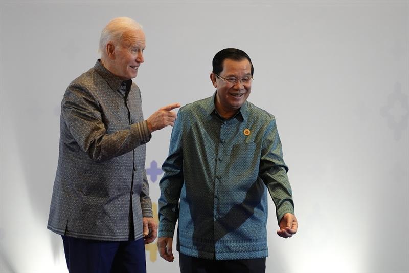 U.S. President Joe Biden, left, is greeted by Cambodia s Prime Minister Hun Sen before the Associati