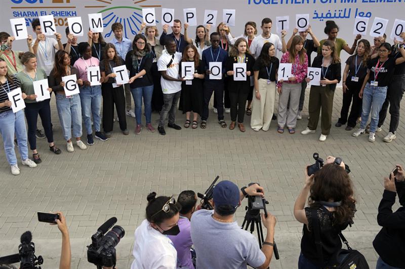 Youth climate activists hold signs that read  from COP27 to G20 fight for 1.5   photo: AP