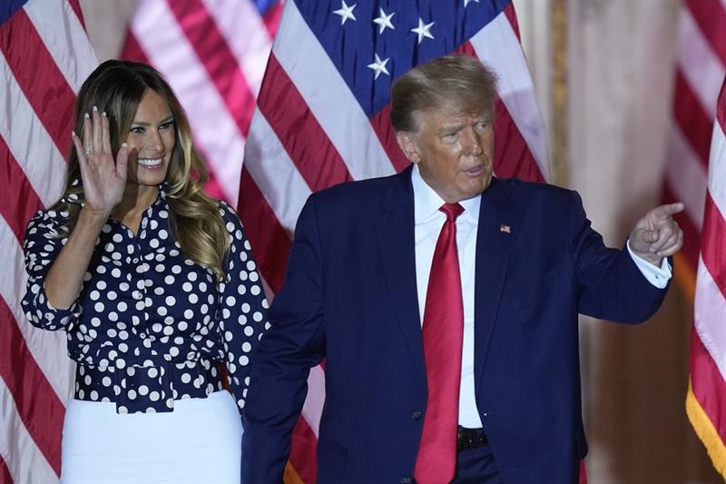 Former President Donald Trump stands on stage with former first lady Melania Trump after announcing 
