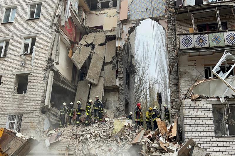 Rescuers of the Ukrainian Emergency Service work in a damaged five-store residential building after 